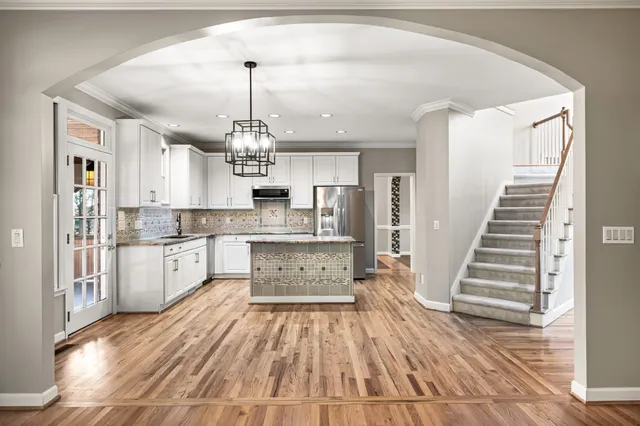 a kitchen with stainless steel appliances granite countertop a stove refrigerator sink and cabinets