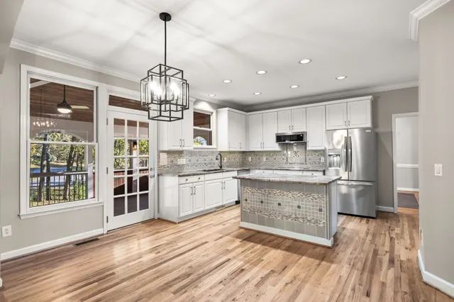 a kitchen with granite countertop a sink stove and cabinets