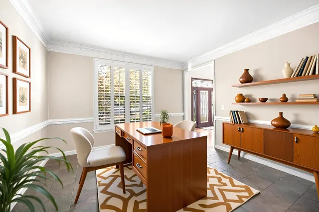 a view of a big room with wooden floor and windows