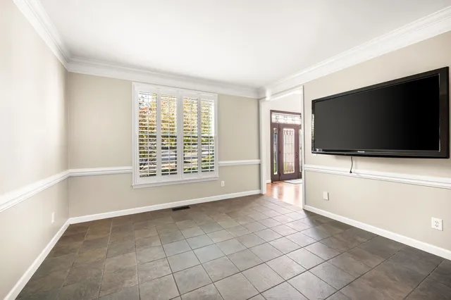 a dining room with furniture a chandelier and wooden floor