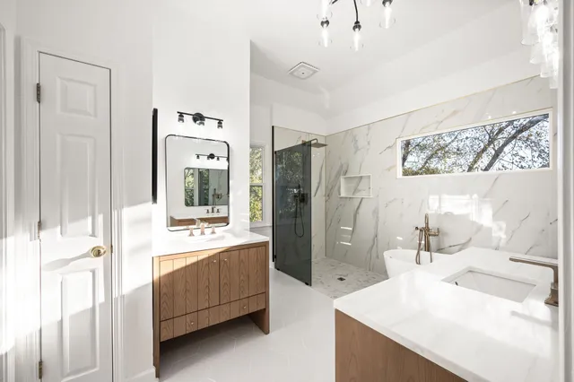 a white tub sitting next to a shower