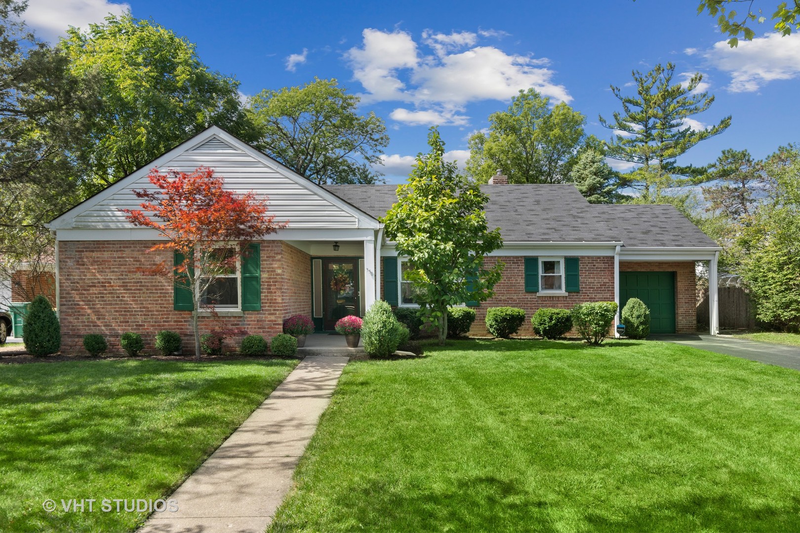 350 Wagner Road Northfield, IL 60093 - Photo 1 of 12 a front view of a house with a garden and yard