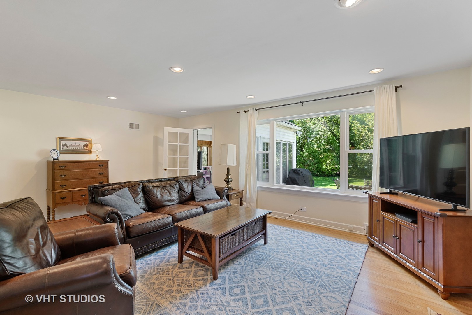 350 Wagner Road Northfield, IL 60093 - Photo 3 of 12 a living room with furniture and a flat screen tv