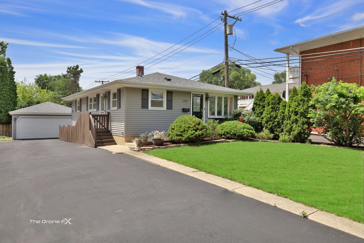 714 Delles Road Wheaton, IL 60189 - Photo 2 of 18 a front view of a house with a garden and plants