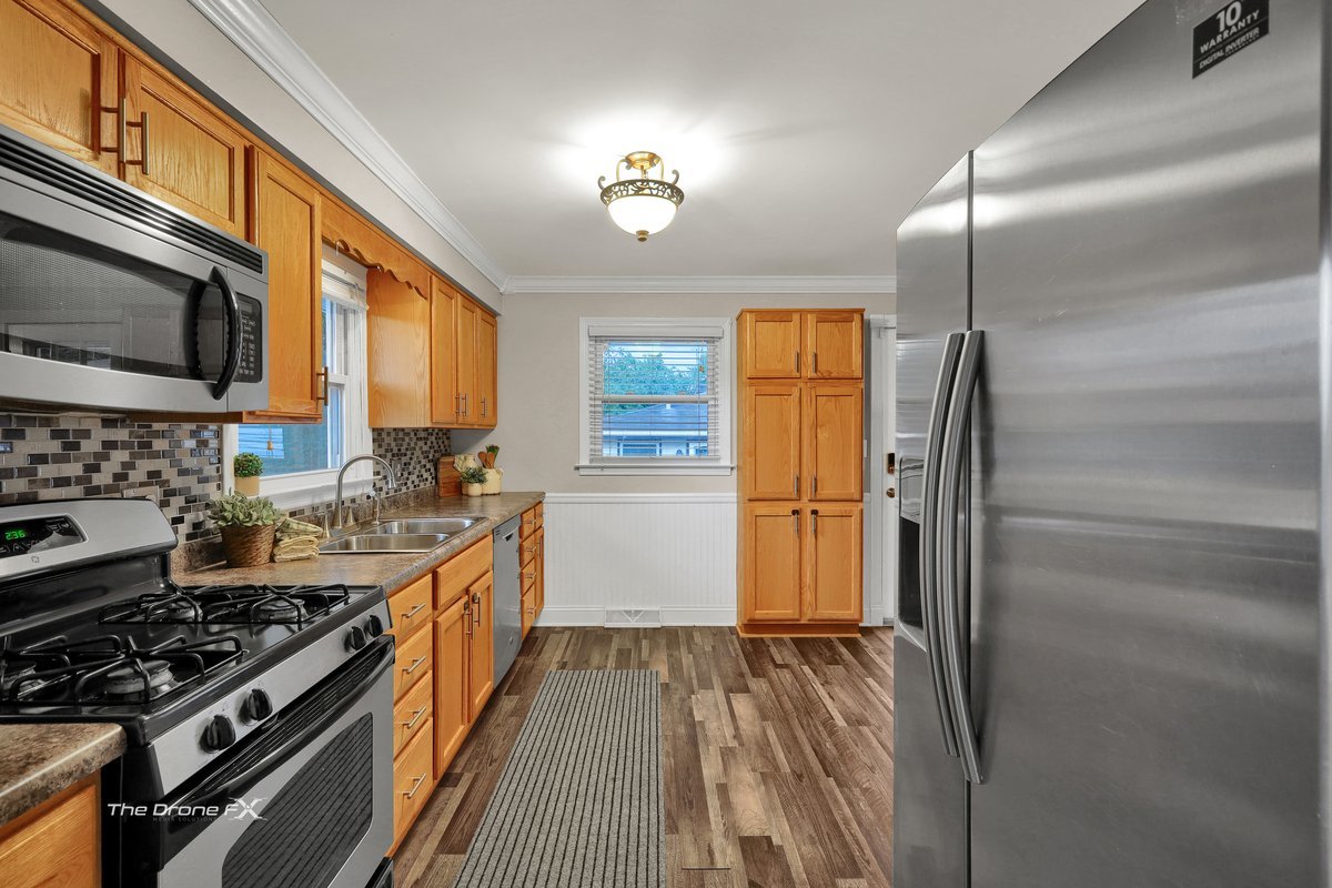 714 Delles Road Wheaton, IL 60189 - Photo 5 of 18 a kitchen with a stove a refrigerator and a stove top oven