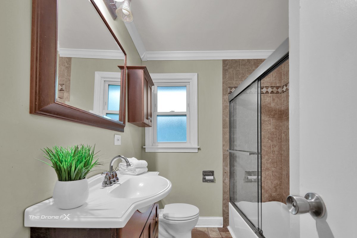 714 Delles Road Wheaton, IL 60189 - Photo 8 of 18 a bathroom with a toilet a sink and mirror