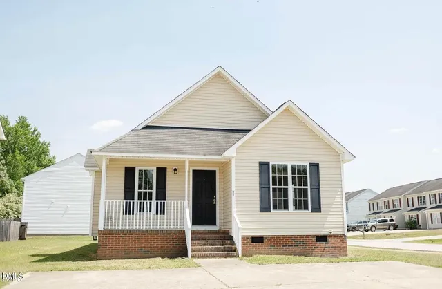 a view of a house with a backyard