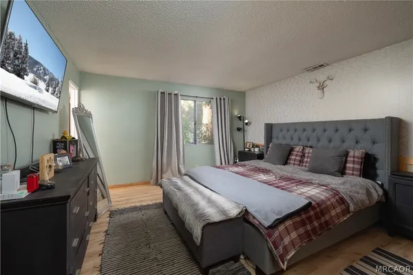 a bedroom with a bed and a mirror