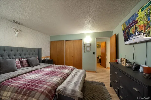 a bedroom with a bed and a dresser