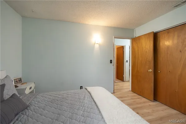 a bedroom with a bed and a mirror