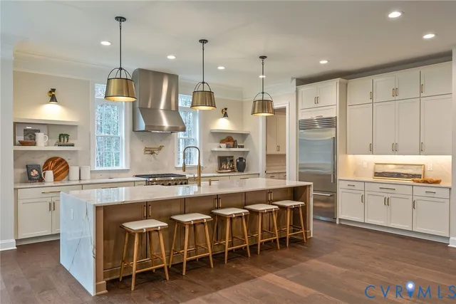 a large kitchen with white cabinets and stainless steel appliances