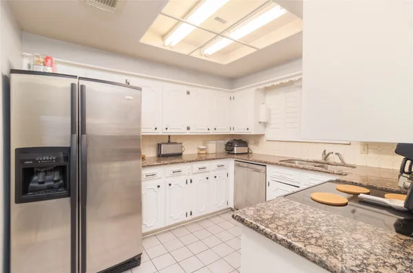 a kitchen with a refrigerator sink and stove