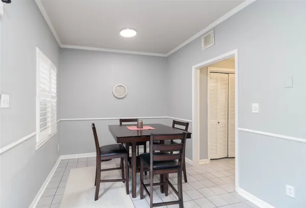 a view of a dining room with furniture and window