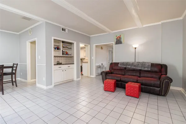 a living room with furniture and kitchen view