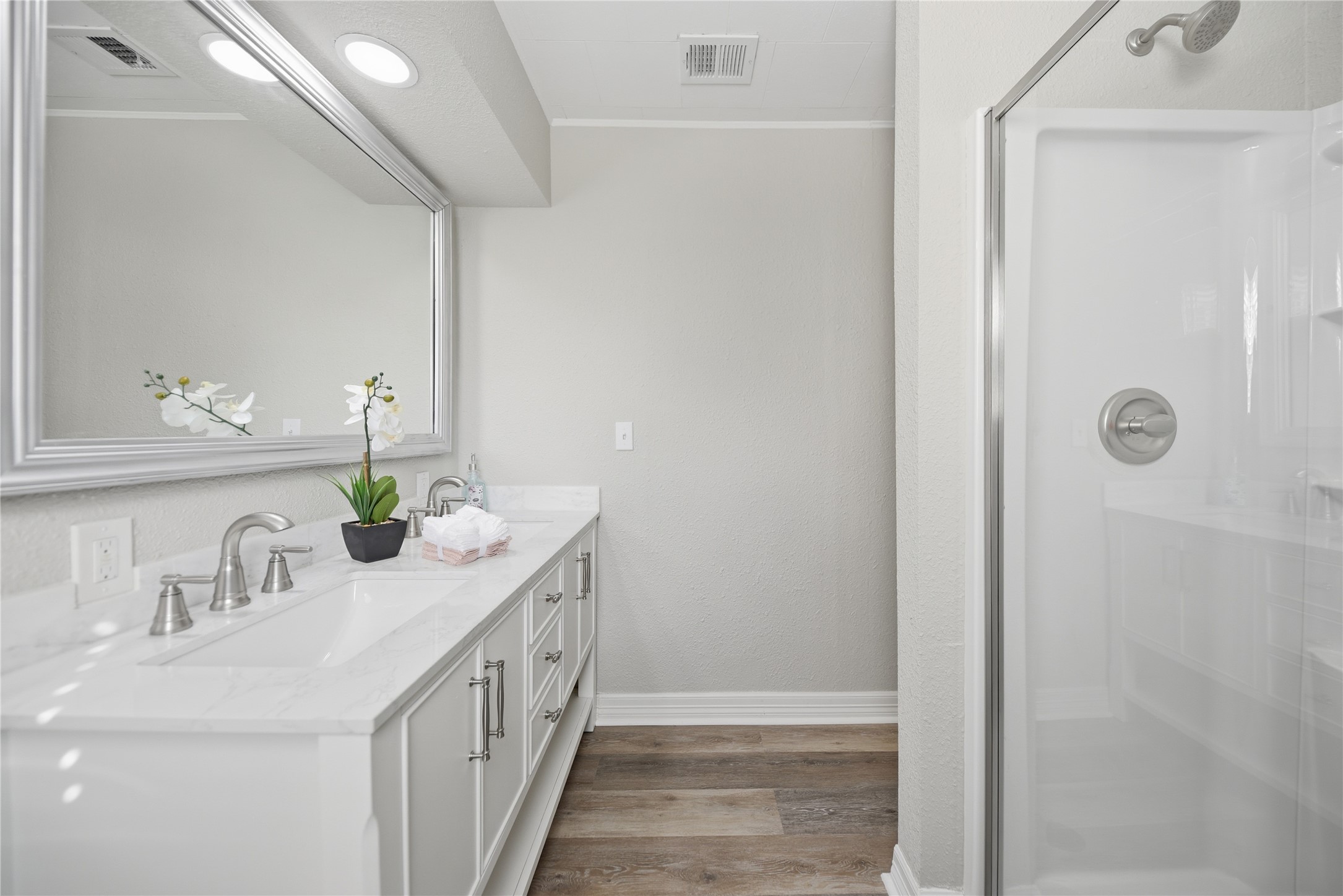 1702 Rampart Street Columbus, TX 78934 - Photo 5 of 38 Bathroom with double vanity, dark wood-style flooring, walk in shower, and ornamental molding