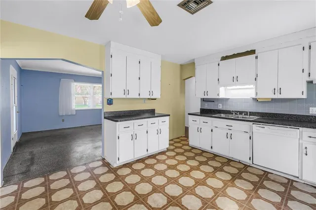a kitchen with stainless steel appliances granite countertop a sink and cabinets