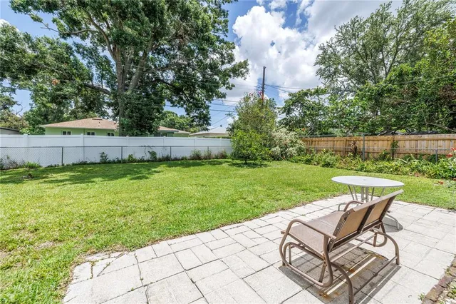 a view of a backyard with sitting area