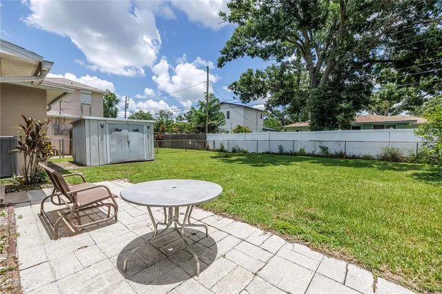 a view of a backyard with furniture and a tub