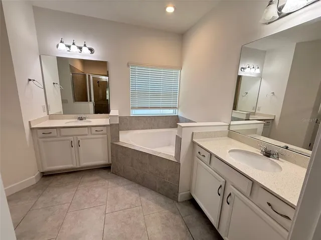 a bathroom with a sink vanity and mirror