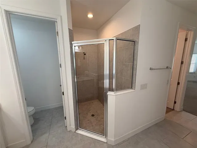 a bathroom with a glass shower door
