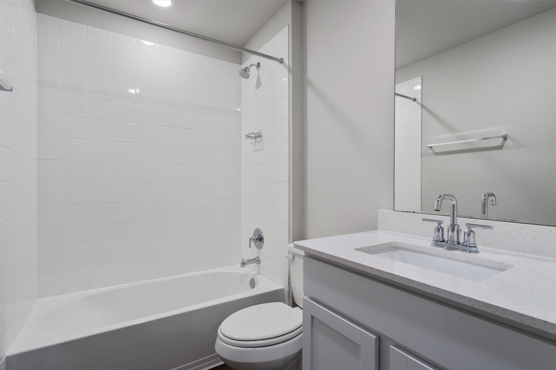 19525 Abigail Fillmore Road Manor, TX 78653 - Photo 24 of 38 A pristine bathroom features a classic bathtub-shower combination and a sleek vanity with ample counter space.