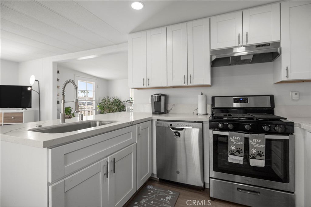 27150 Shadel Road, Unit 122 Menifee, CA 92586 - Photo 9 of 26 a kitchen with stainless steel appliances granite countertop a sink and a stove