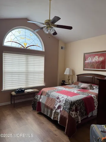 a bedroom with a bed and a chandelier