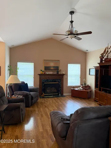 a living room with furniture a fireplace and a flat screen tv
