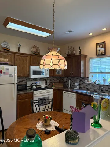 a kitchen with a sink appliances and cabinets