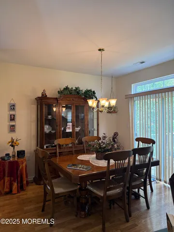 a dining room with furniture and window