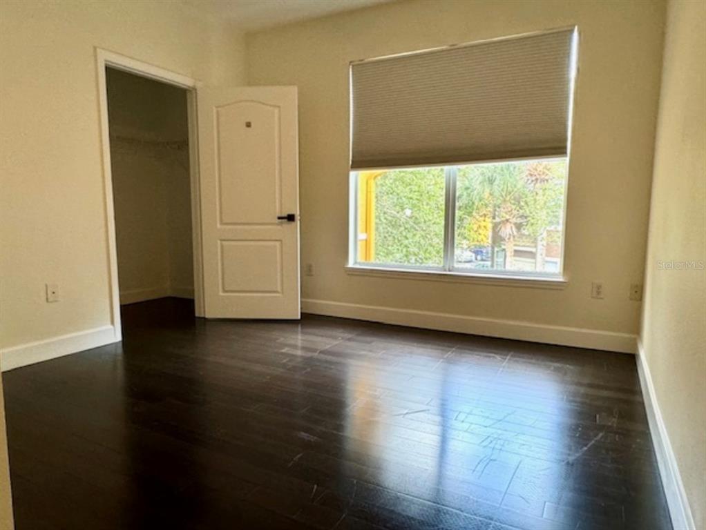 8843 Villa View Circle, Unit 207 Orlando, FL 32821 - Photo 18 of 36 an empty room with wooden floor and windows