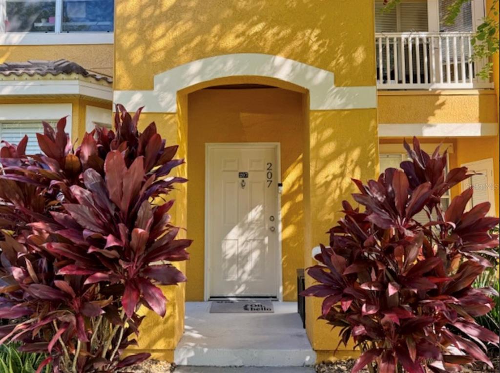 8843 Villa View Circle, Unit 207 Orlando, FL 32821 - Photo 2 of 36 a view of a house with a tree