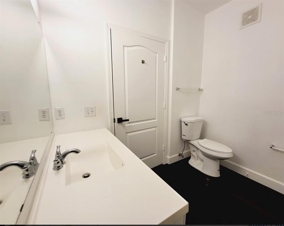 8843 Villa View Circle, Unit 207 Orlando, FL 32821 - Photo 21 of 36 a bathroom with a granite countertop toilet a sink and bathtub