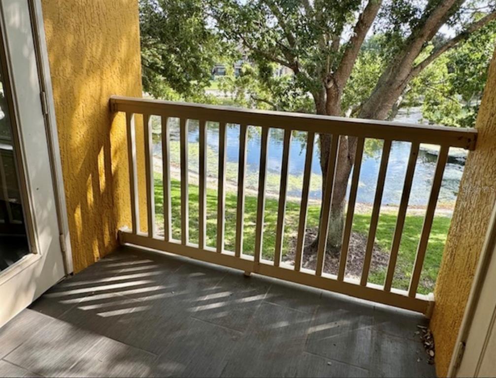 8843 Villa View Circle, Unit 207 Orlando, FL 32821 - Photo 24 of 36 a view of a balcony with wooden floor