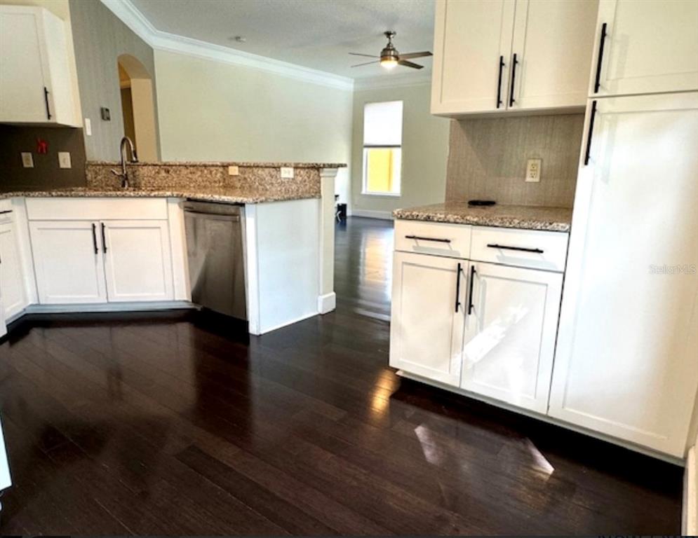 8843 Villa View Circle, Unit 207 Orlando, FL 32821 - Photo 6 of 36 a kitchen with granite countertop a stove a sink and a refrigerator