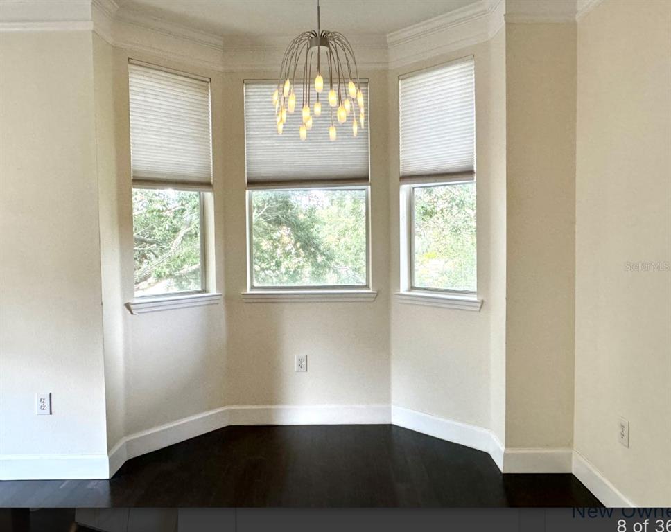 8843 Villa View Circle, Unit 207 Orlando, FL 32821 - Photo 8 of 36 a view of empty room with wooden floor and fan