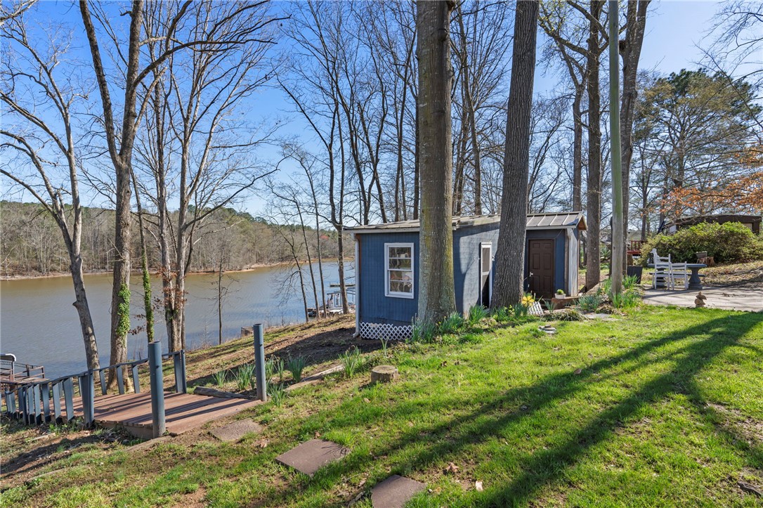122 Latham Drive Anderson, SC 29621 - Photo 27 of 40 This serene lakeside property boasts a private dock and mature trees, creating a peaceful natural retreat.