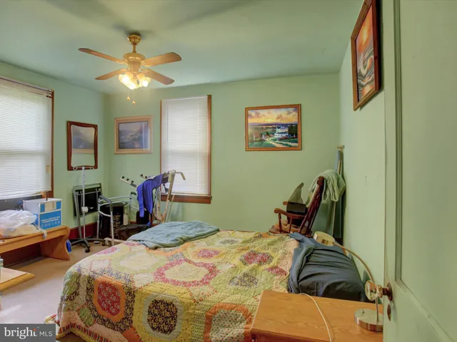 a bedroom with bed and a chandelier
