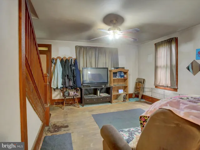 a bedroom with furniture and a flat screen tv