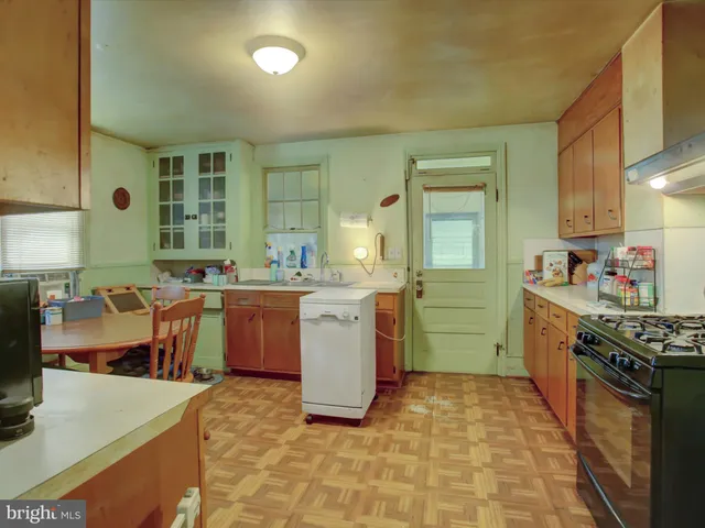 a kitchen with a sink appliances and cabinets