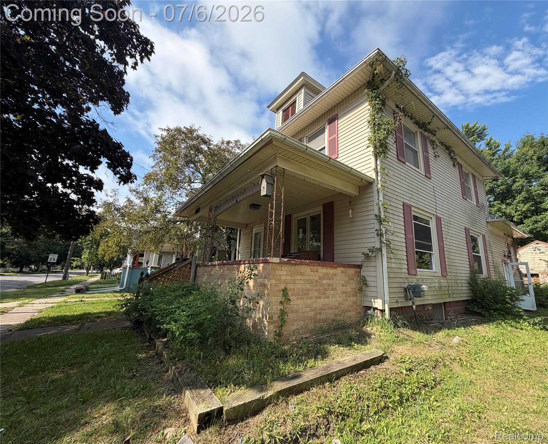 808 Division Street Owosso, MI 48867 - Photo 25 of 25 Two-story property featuring light-colored siding and a covered front porch with a brick base