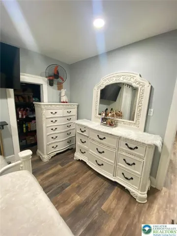 a living room with furniture a rug and white walls