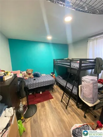 a bedroom with a bed and a table in it