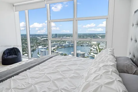 a large bed sitting in a bedroom next to a window