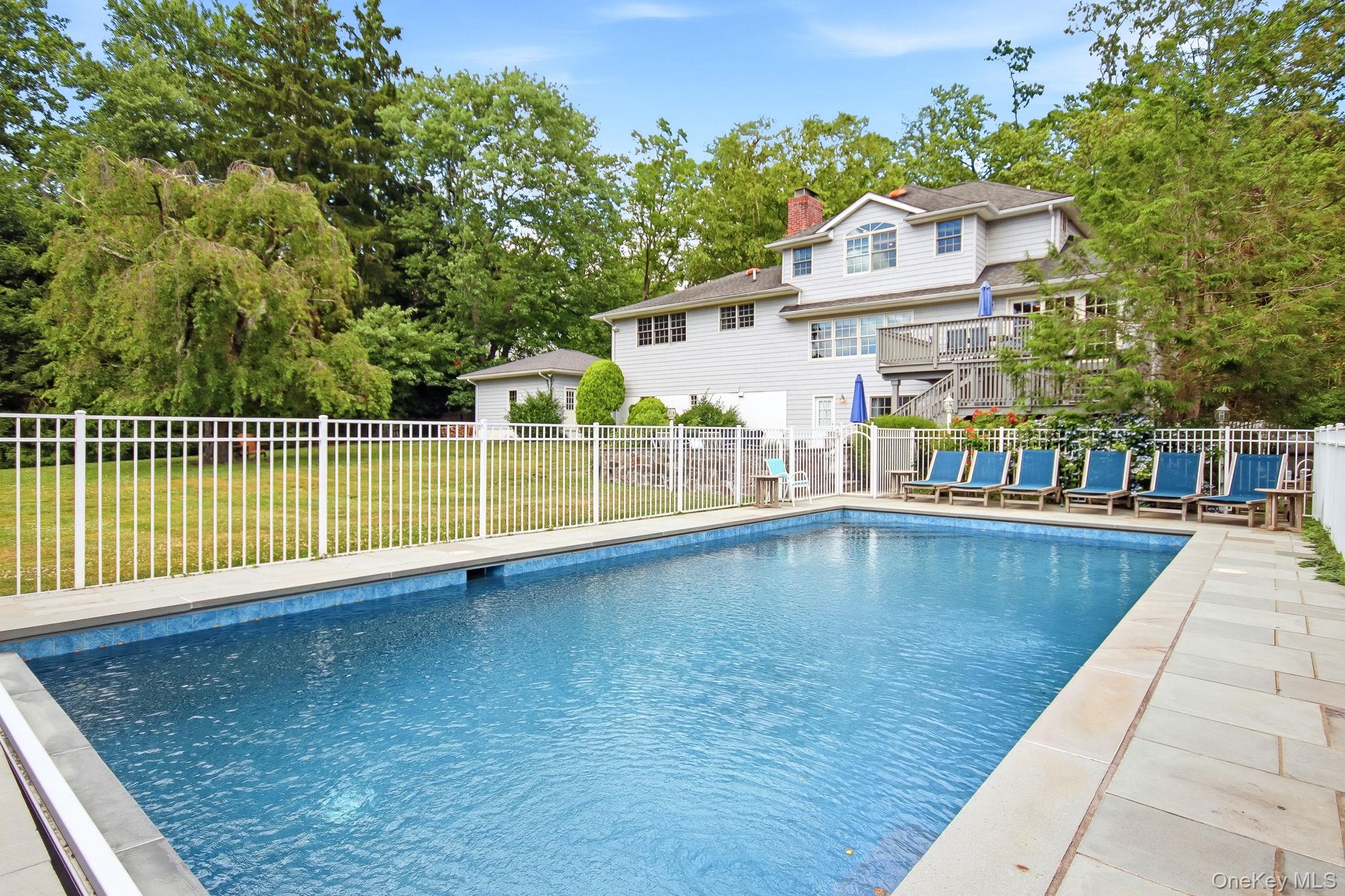 26 Century Ridge Road Purchase, NY 10577 - Photo 38 of 50 In-ground swimming pool with surround, featuring a white fence