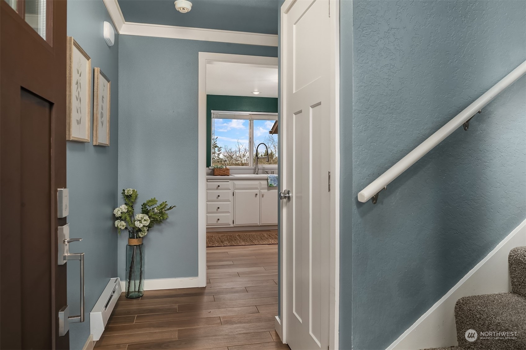 1615 Eagle Ridge Drive South, Unit 4 Renton, WA 98055 - Photo 3 of 29 a view of a hallway with wooden floor and a livingroom