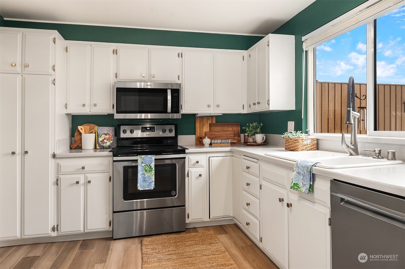 1615 Eagle Ridge Drive South, Unit 4 Renton, WA 98055 - Photo 5 of 29 a kitchen with white cabinets stainless steel appliances and sink