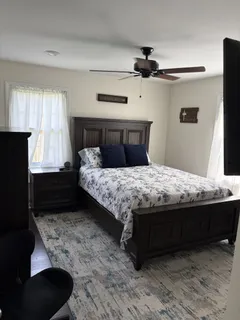a bedroom with a bed and a window