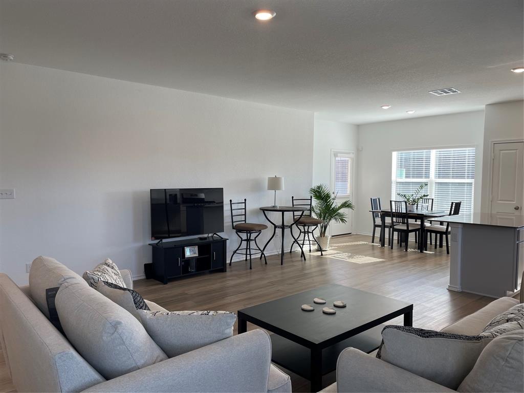 129 Starflower Cove Georgetown, TX 78628 - Photo 4 of 31 Living area featuring wood finished floors and recessed lighting