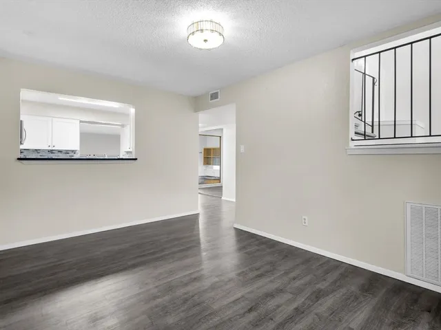 a kitchen with cabinets stainless steel appliances and wooden floor